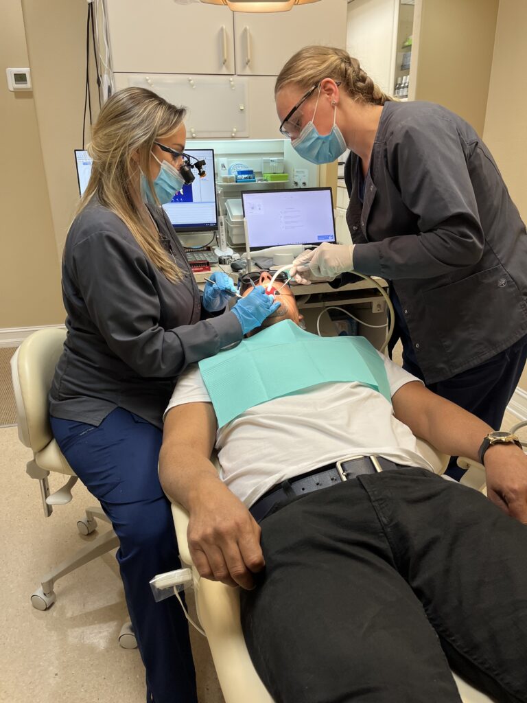 Dr Perez and Karlie dental assistant working (1)